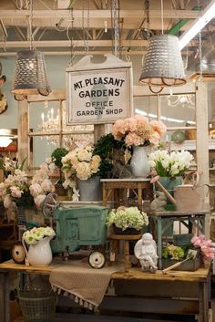 a flower shop filled with lots of vases and flowers