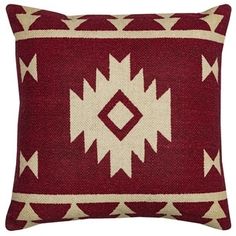 a red and white pillow with an intricate design on the front, sitting on a white background