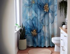 a blue flower shower curtain in a bathroom