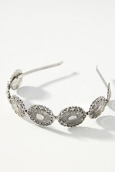 the headband is made from metal and has filigrees