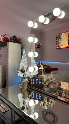 a lighted christmas tree sits in front of a mirror with the word sale written on it