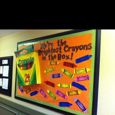 a bulletin board with crayons in the box on it next to other bulletin boards