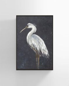 a painting of a white crane on a black background in a frame hanging on the wall