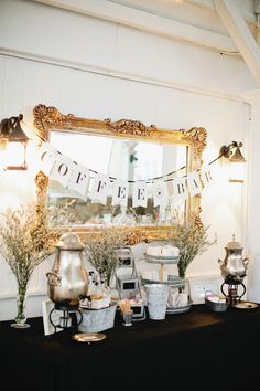 there is a table with coffee and tea cups on it in front of a mirror