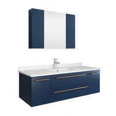 a white sink sitting under a mirror next to a blue cabinet