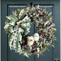 a christmas wreath with two white dogs on it