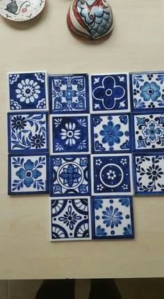 blue and white tiles are laid out on a table