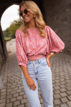 Perfect for dressing up or dressing down, our pink, paisley-patterned Karlou blouse is the ultimate summer wardrobe staple. Featuring a crewneck, a drawstring to tie on back, and 7/8th length balloon sleeves, this blouse is slightly cropped and totally adorable. Our model is also wearing the Larou skirt and Maddie jeans One size (fits from US 2-4-6-8) Length 18.5 in - Width 13.78 in 100% viscose Washing: handwash only Trendy Cropped Blouse With Blouson Sleeves, Spring Pink Tops With Elastic Sleeves, Spring Cropped Blouse With Elastic Sleeves, Pink Tops With Elastic Sleeves For Spring, Chic Paisley Print Top For Day Out, Casual Pink Tops With Elastic Sleeves, Pink Summer Tops With Elastic Sleeves, Spring Crop Top Blouse With Blouson Sleeves, Trendy Pink Puff Sleeve Long Top