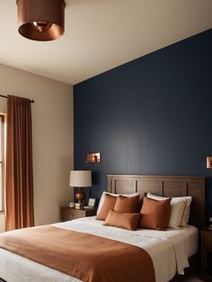 a bedroom with blue walls and brown bedding