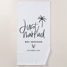 a white towel with the words, just married and palm trees in black on it