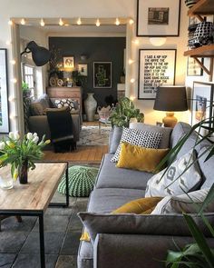 a living room filled with furniture and lots of lights on the wall above it's windows