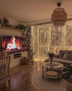 a living room filled with furniture and a flat screen tv sitting on top of a wooden floor