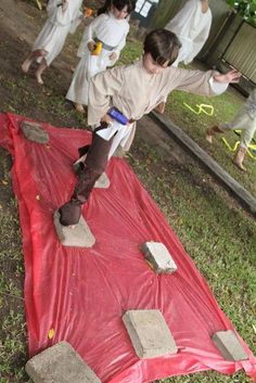 a group of people in costume standing on top of a red tarp