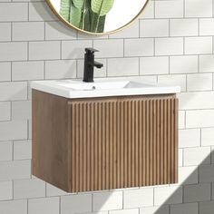 a bathroom sink with a mirror above it and a wall mounted faucet next to it