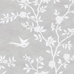 white flowers and birds are on a gray wallpaper with light grey paper behind it