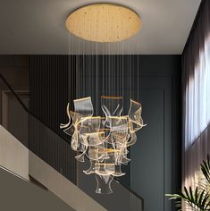 a chandelier hanging from the ceiling in a room with black walls and stairs