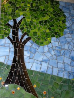 a tree is depicted on a mosaic tile wall