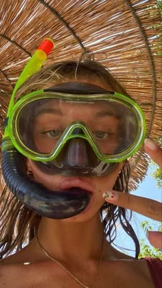 a woman wearing goggles and snorkels is making a funny face with her mouth