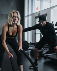 a man and woman doing exercises in a gym