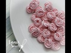 a white plate topped with pink frosted roses