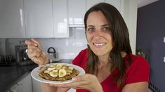 a woman holding a plate with some food on it