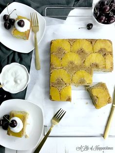 slices of pineapple upside down cake with whipped cream and cherries on the side