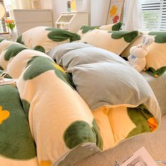 a bed with green and yellow pillows on top of it