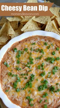 cheesey bean dip in a white bowl surrounded by tortilla chips