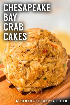 a close up of some food on a wooden board with the words cheesecake bay crab cakes