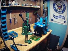 a room filled with lots of tools on top of a wooden table in front of a flag