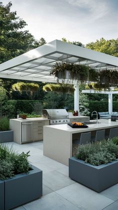 an outdoor kitchen with grill and seating area