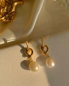 Gold Plated Pearl Tied Knot Earrings #pearljewelry #pearls #pearl #jewelry #pearlnecklace #pearlearrings #lhypearl #jewellery #freshwaterpearls #southseapearls #pearljewellery #earrings #handmadejewelry #pearlbracelet #bridaljewelry #kundanjewellery #necklace #mutiaralombok #jewelryaddict #diamond #tahitianpearls #pearllover #fashion #finejewelry #jewelrydesigner #southseapearl #mutiaralaut #templejewellery #pearlring Tied Knot, Kundan Jewellery, South Sea Pearls, Tahitian Pearls, Temple Jewellery, Tie Knots, Pearl Ring, Pearl Bracelet