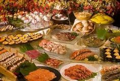 a table filled with lots of different types of food and desserts on it's sides