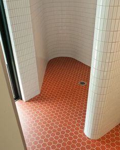 an orange and white tiled floor in a bathroom