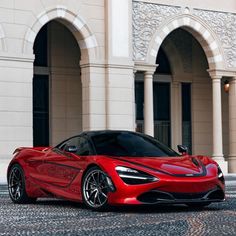 a red sports car parked in front of a building