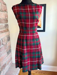 VINTAGE 1950's PLAID PLEATED DRESS WOOL RED, GREEN, AND WHITE PLAID PLEATED DRESS/JUMPER WITH METAL ZIPPER AND UNION TAGS MEASUREMENTS ARE TAKEN FLAT, DOUBLE WHERE NECESSARY- *LENGTH- 35.5" *WAIST-13" *BUST- 16" *SLEEVE- 7" OPENING *SHOULDER TO SHOULDER - 15" *HIP-16-18" *ZIPPER-19" Dress is in EXCELLENT CONDITION! Plaid A Line Dress, Vintage Plaid A-line Dress, Vintage Lined Plaid Dress, Red Plaid Dress Outfit, Plaid Dress Outfit, Red Plaid Dress, Vintage 1950s Dresses, Wool Dress, Plaid Dress