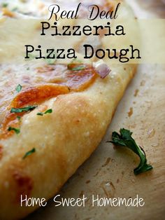 a close up of a slice of pizza on a cutting board with the words real deal pizza