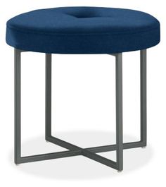 a blue stool sitting on top of a metal frame footstool in front of a white background