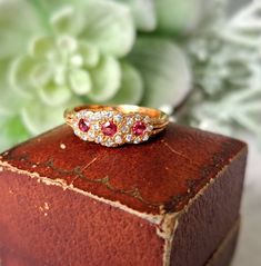 Vintage 18ct Gold, Ruby & Diamond Ring.  Hallmarked London 1983, Makers Mark J&P Size O (EU 56, US 7.5). Free Resizing Available - please message or email info@sobellejewellery.com Weight: 3.9g Rubies: 3 x 2mm Diamonds: 22 x 1mm Condition:  Good, clean vintage condition. All items will have a full professional clean and polish upon dispatch.  My items are all vintage so please study the photographs where I try to show as much detail as possible. Any damage or obvious imperfections will be clearl Cluster Yellow Gold Hallmarked Rings, Yellow Gold Cluster Rings Hallmarked, Yellow Gold Cluster Ring With Hallmark, Heirloom Gold Ruby Ring With Diamonds, Classic Ruby Ring With Rose Cut Diamond Cluster, Luxury Ruby Ring With Rose Cut Diamonds For Anniversary, Ruby Rings With Single Cut Diamonds, Yellow Gold Cluster Jewelry With Rose Cut Diamonds, Formal 14k Gold Ruby Ring With Single Cut Diamonds