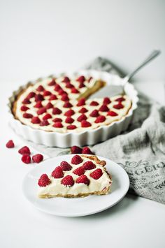 a slice of cheesecake with strawberries on top and a fork next to it