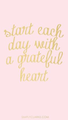 the words start each day with a grateful heart in gold foil on a pink background