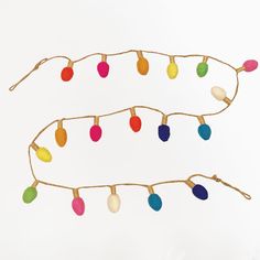 a string of christmas lights on a white background