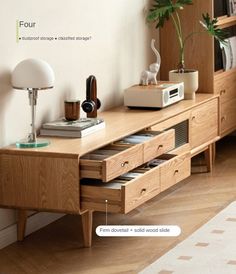 a wooden table with drawers and a lamp on it's side next to a book shelf