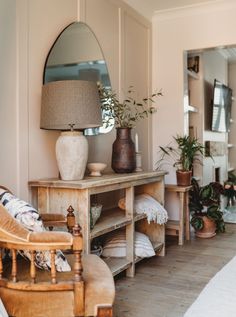 a living room filled with furniture and potted plants on top of a wooden table