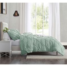 the comforter is made up and ready to be used in any room with it's light green color