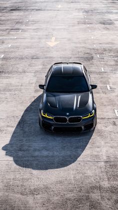 a black car parked in an empty parking lot