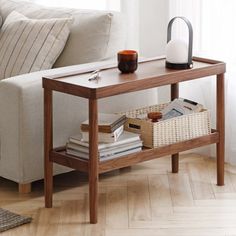 a living room with a couch, coffee table and books on the shelf next to it