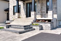 a house with stone steps leading up to the front door and flower boxes on either side