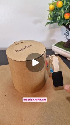 a video demonstrating how to make a cardboard box with the word tracc on it