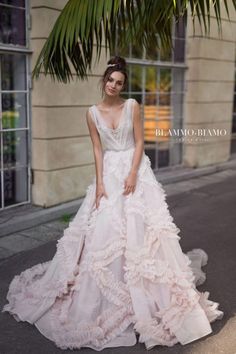 a woman in a wedding dress standing on the street